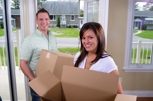 Packing boxes and wrapping fragile items in a Spitalfields home