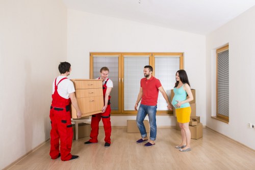 Professional movers handling furniture in an East London property