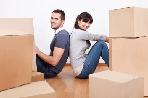 Home removal team carrying furniture through a Spitalfields property